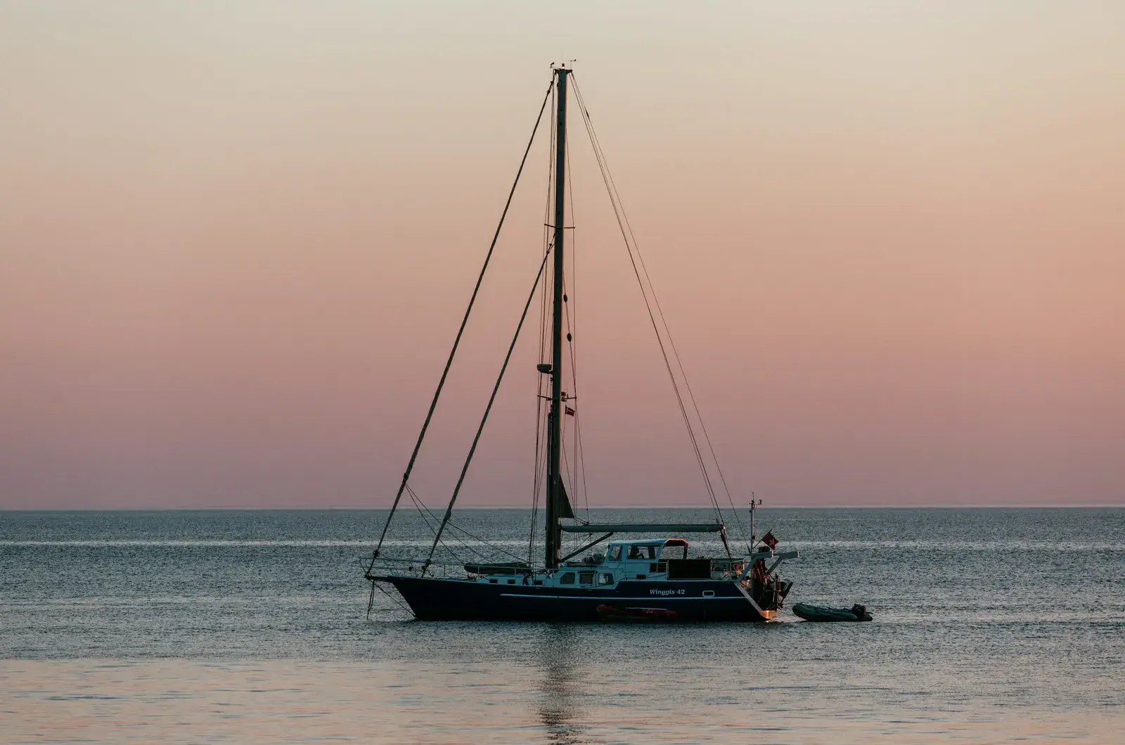 Sejlbåd for anker i solnedgang